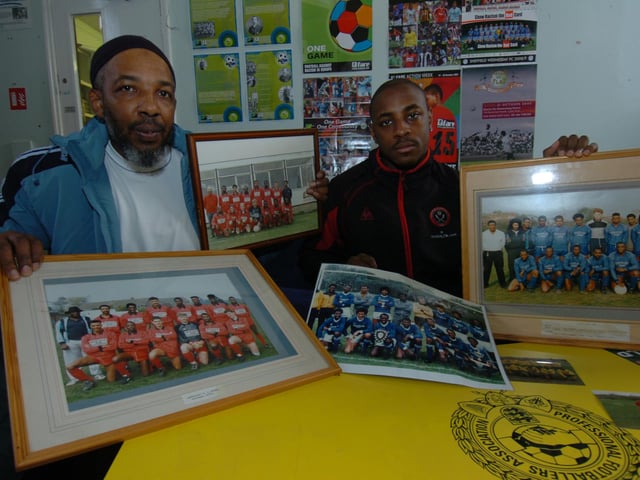 Ishaaq Heywood and Jarvis Salmon with some of the old football pictures that will be used in an exhibition about black football in Sheffield in 2009