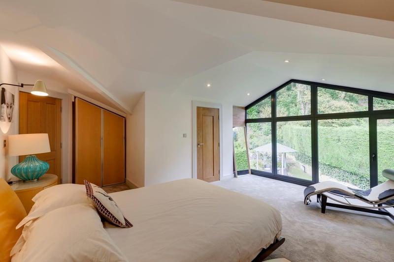 Bedroom 2 is a generously sized double bedroom with rear facing aluminium double glazed window and panels, recessed lighting and wall mounted light points. There’s a range of fitted furniture, incorporating short/long hanging and shelving.