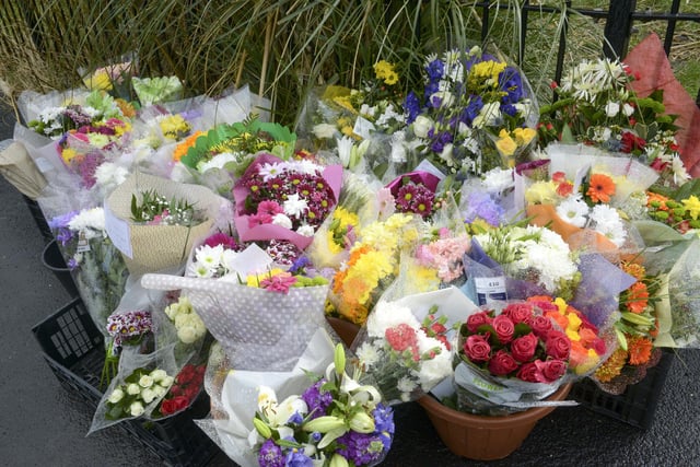 Floral tributes have been left close to the murder scene.