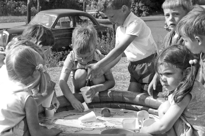 St Hilda's play group members take advantage of the sunshine to enjoy a cooling paddling pool in July 1971.