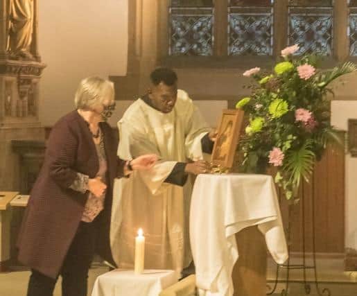 Christin Wood, from St Mary’s Penistone, and St Marie's seminarian Christian Nwakamma display an icon of Our Lady of Perpetual Succour at the opening celebration for the Synod on Synodality in the Diocese of Hallam.