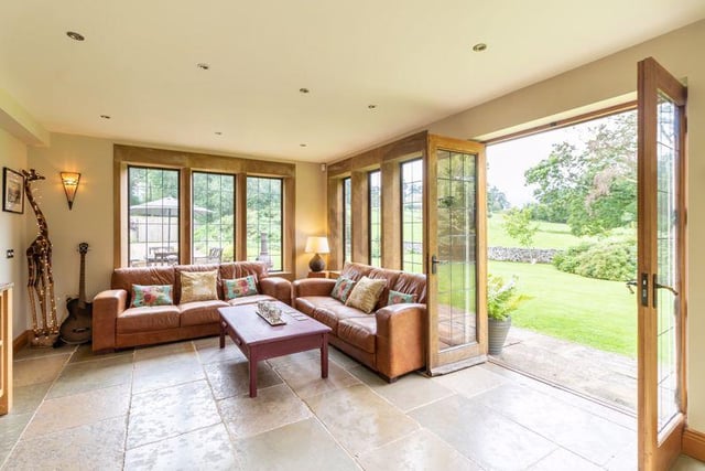 There are four reception rooms throughout the property, including this spacious sitting area which benefits from underfloor heating and French windows leading out to the stone fluffed rear terrace.