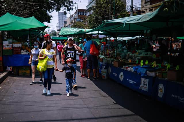Residents, some in face masks, in a Mexico City street market