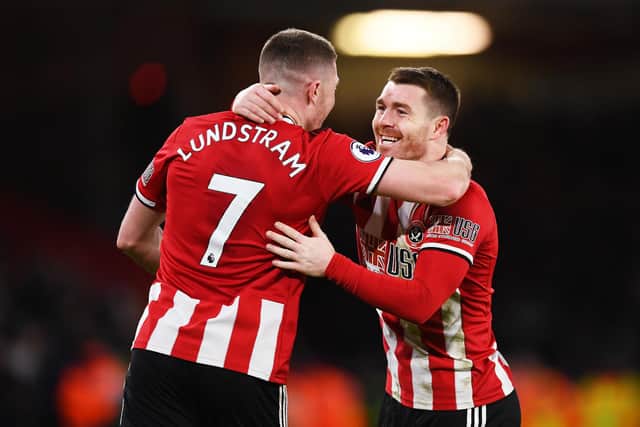 John Fleck of Sheffield United celebrates with teammate John Lundstram after scoring his team's second goal during the Premier League match between Sheffield United and Aston Villa at Bramall Lane on December 14, 2019 in Sheffield, United Kingdom. (Photo by Clive Mason/Getty Images)