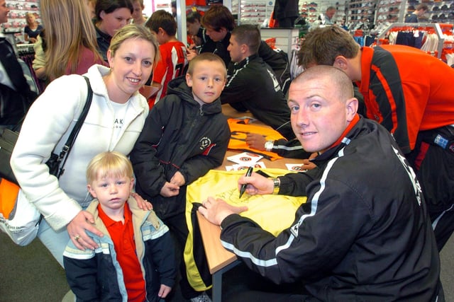 Paddy Kenny signs the jersey of 10 year old Ryan Goodwin with brother Luke Goodwin, aged 3 and mum Tracy Jackson from the Wybourn, Sheffield.