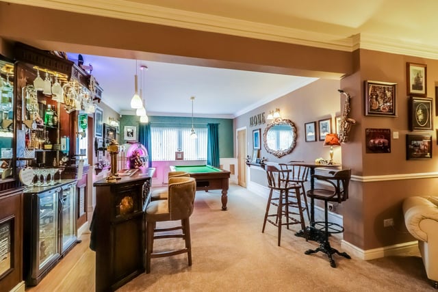 This spacious reception room is currently being used as a games room with a separate bar area and music station, providing a perfect relaxation space.