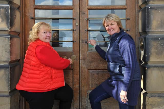 Dame Julie Kenny, Chair of Trustees Wentworth Woodhouse Preservation Trust and Sarah McLeod, trust CEO, lock the front door of the house, as they temporarily shut it down due to the coronavirus outbreak.
