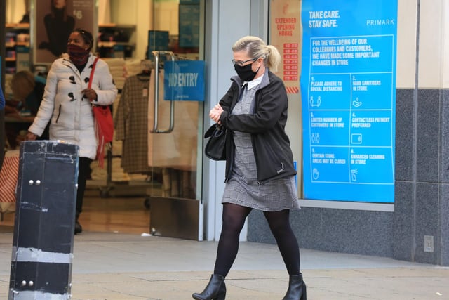 A pedestrian walks past the entrance to Primark