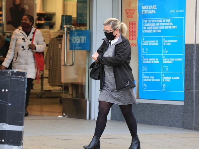 A pedestrian walks past the entrance to Primark