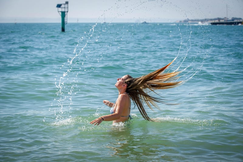 Lucy Wright having cooling her head in the sea at the Hot Walls in Old Portsmouth. Picture: Habibur Rahman