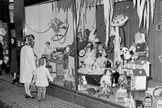 A mum and child inspect the Christmas window display at Patrick Thomsons, on North Bridge, in 1965.