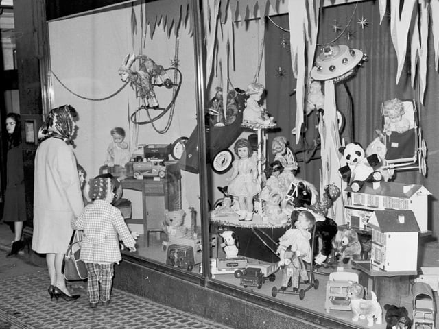 A mum and child inspect the Christmas window display at Patrick Thomsons, on North Bridge, in 1965.