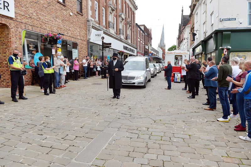 Don started on the market aged seven and was known for his famous voice booming over the marketplace. People lined up to clap the procession and remember him.