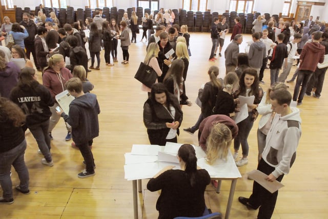Scores of Year 11 pupils receive their GCSE results in 2014.