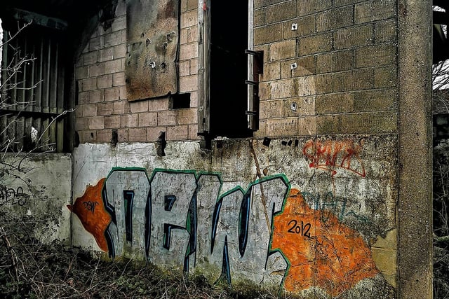 More graffiti inside an outbuilding.