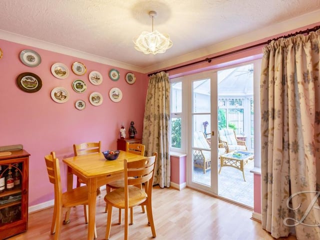 From the living room, find your way into this dining room, which is the ideal place for a family meal. As you can see, it has access to the conservatory.
