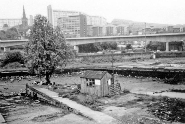 Sheffield Canal Basin was drained for renovation work in 1993. This photo shows the area, with Hyde Park flats and the Supertram viaduct in the background