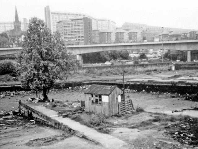 Sheffield Canal Basin was drained for renovation work in 1993. This photo shows the area, with Hyde Park flats and the Supertram viaduct in the background