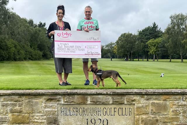 Ellie receives a cheque from Clive at Hillsborough Golf Club