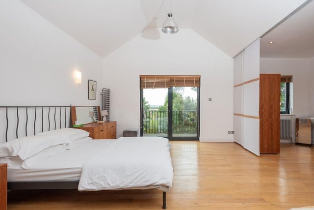 The master bedroom is incredibly large, with tons of floor space and a balcony to access.