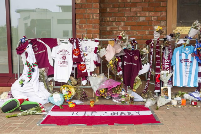 Hearts fans paid tribute to much-loved supporter Frank 'Shaky' Walker with maroon scarves, tops and flowers at Tynecastle Park.