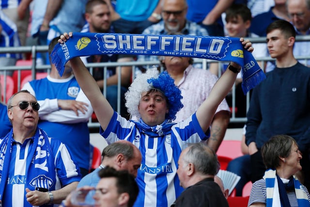 A Wednesday fan holds aloft a scarf before the Championship play-off final against Hull City at Wembley in May 2016.