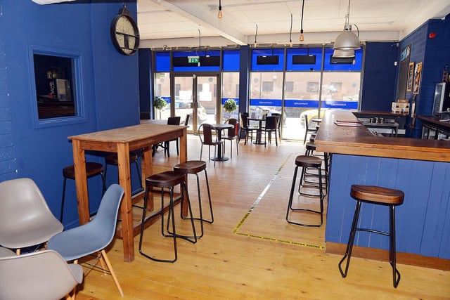 The TapHouse has a bar topped with polished wood and walls painted in a smart shade of blue.