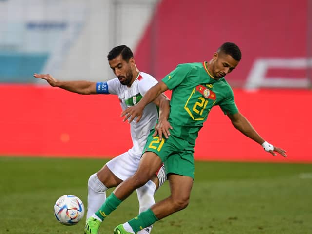 Iran's defender Ehsan Hajisafi (L) and Senegal's midfielder Iliman Cheikh Baroy Ndiaye vie for the ball during the friendly football match between Senegal and Iran in Moedling, Austria on September 27, 2022. (Photo by JAKUB SUKUP / AFP) (Photo by JAKUB SUKUP/AFP via Getty Images)