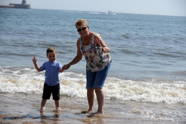 Youngster Kai Smith, three, with with nana Sandra Smith cooling off at Roker Beach.