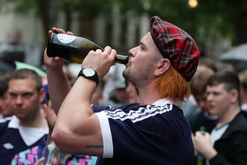 A man seen downing a bottle of wine in a Jimmy hat as he supports the Scotland team (Photo: Kieran Cleeves/PA Wire).