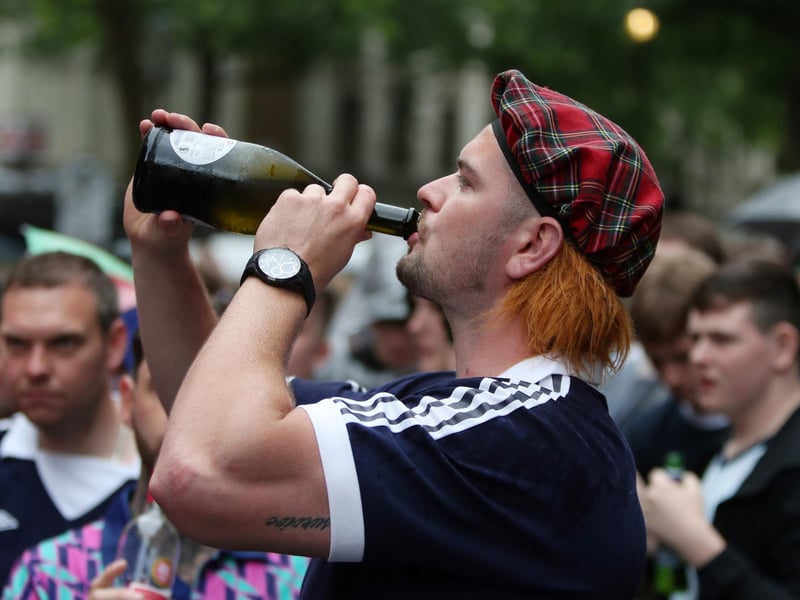 A man seen downing a bottle of wine in a Jimmy hat as he supports the Scotland team (Photo: Kieran Cleeves/PA Wire).