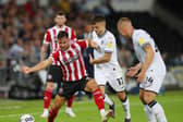 George Baldock of Sheffield United tussles with Jamie Paterson of Swansea City during the Sky Bet Championship match at the Swansea.com Stadium, Swansea. Photo: Simon Bellis / Sportimage