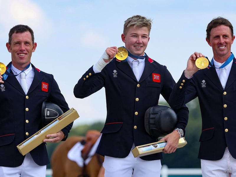 Team GB's gold medal winners in the equestrian's jumping team final show off their medals.