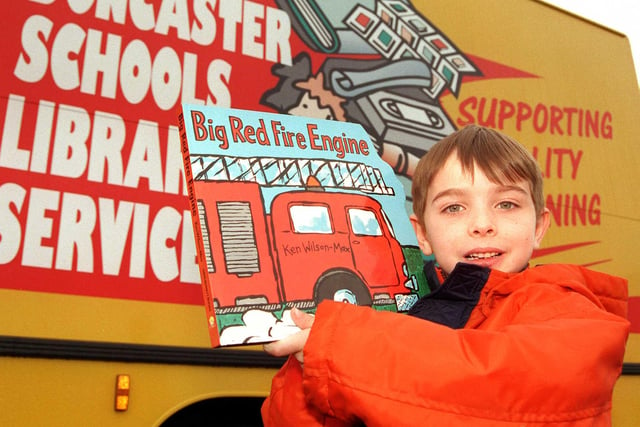 Corey Johnson, aged six, of Skellow, with a book from the Doncaster Schools' Library Service bus in 1999