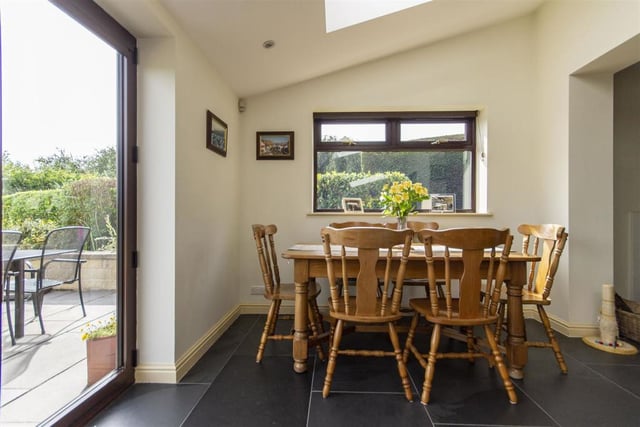 The dining room has a vaulted ceiling and bi-fold doors which open onto a front patio.