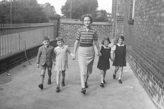 Miss Bright, of Chester Road School, takes two pairs of evacuee twins, Jean and Betty Edmonds and Arthur and Lilian Hepburn for a walk in 1939 after their evacuation to Yorkshire.
