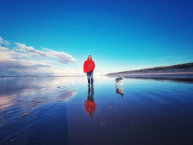 One man and his dog enjoy a stroll at Bamburgh beach back in April.
