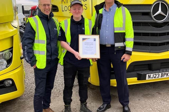Lorry driver Kieran Walsh, who stopped a man from jumping from a motorway bridge in South Yorkshire is presented with an award by Richard Smith and Michael Spence, of the logistics firm Kinaxia, for which he works
