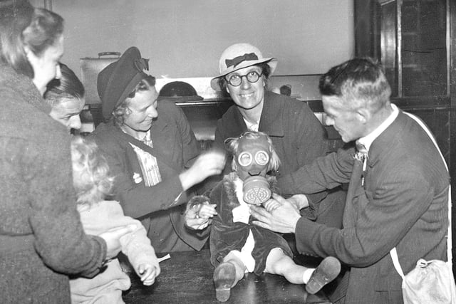 For those staying at home, knowing how to use a gas mask was vital. One baby is being fitted with their mask in this 1939 photo.