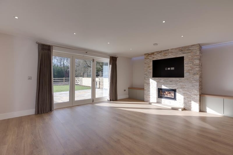 The focal point of the room is the feature wall with a Stovax log burner and having the provision for a wall-mounted television.
