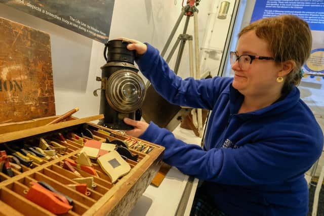 Rosie Norrell puts the finishing touches to a communication display at coastguard history exhibition Guarding the Coast at the National Emergency Services Museum, Sheffield