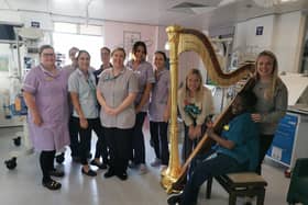 Harpist Louise Thomson and cellist Polly Ives with children's hospital staff