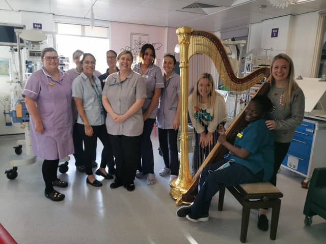 Harpist Louise Thomson and cellist Polly Ives with children's hospital staff