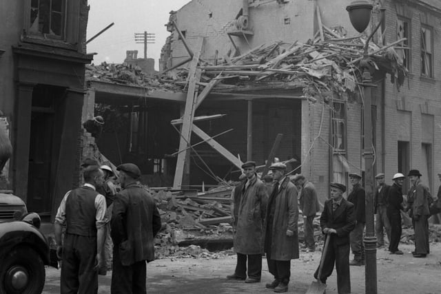 Locals survey the effect of an autumn air raid attack in 1941.