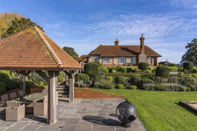 Built on the site of the former stables to the Hunting Lodge of Arundel Castle, this attractive Arts and Crafts style country house looks out onto the open South Downs countryside and includes almost four acres of gardens with a swimming lake and summer house. Price: £3,950,000.