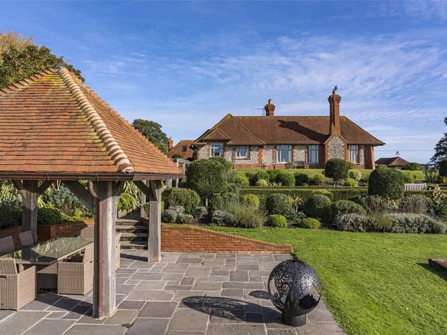 Built on the site of the former stables to the Hunting Lodge of Arundel Castle, this attractive Arts and Crafts style country house looks out onto the open South Downs countryside and includes almost four acres of gardens with a swimming lake and summer house. Price: £3,950,000.