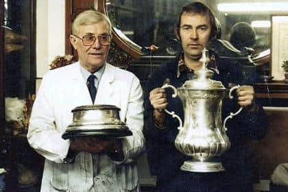 Bill Justice holding the FA Cup with Bernard Halliwell, the holloware manager, in the Frank Cobb silverware firm showroom