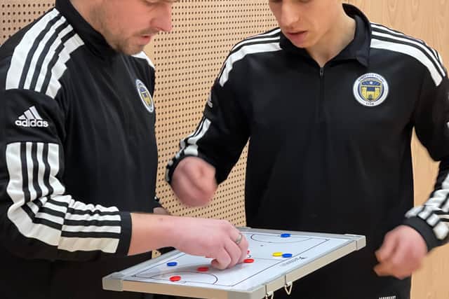 Sheffield Futsal Club management draw up tactics for a game.