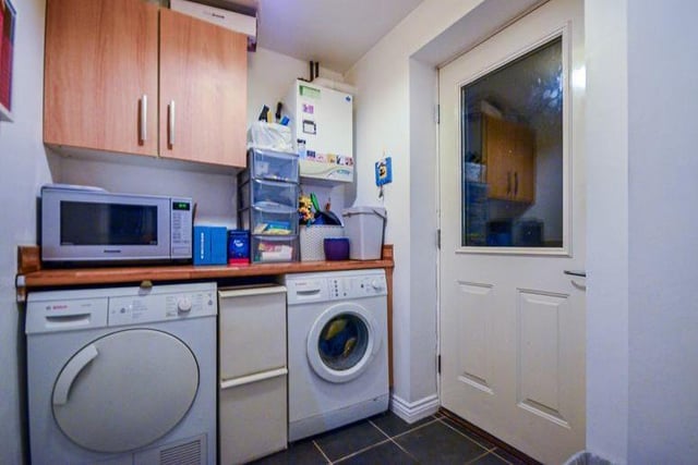 The useful utility room, off the kitchen, provides more valuable space for appliances such as a washing machine and tumble dryer.