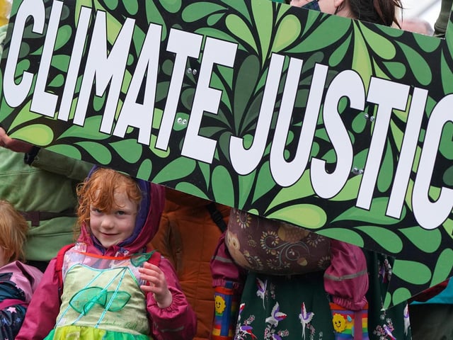 Climate Justice Activists at the Cop26 Gates asking delegates as they make final decisions, "Are You With Us Or With Fossil Fuels?" during the official final day of the Cop26 summit in Glasgow.